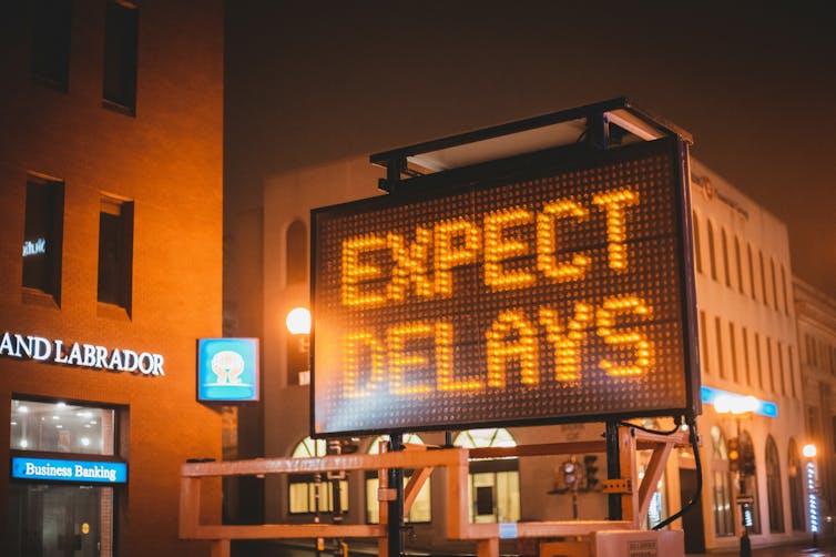 An electronic road sign which reads expect delays.