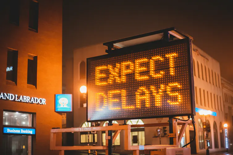 An electronic road sign which reads expect delays.