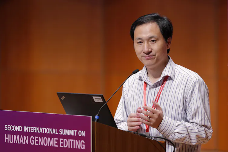 Man with black hair and wearing a business shirt speaks at a lectern.