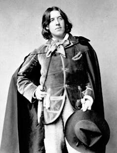 Oscar Wilde in a velvet cloak.