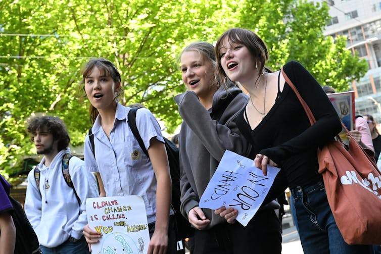 Young people march at a rally.