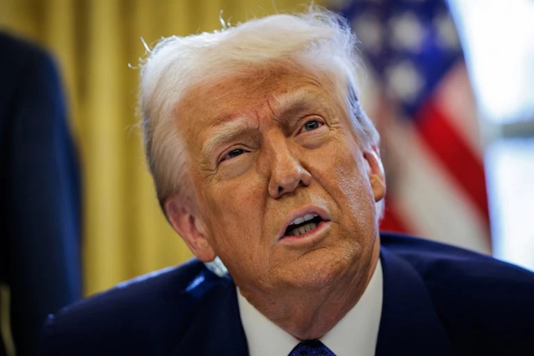 Donald Trump in front of a US flag.