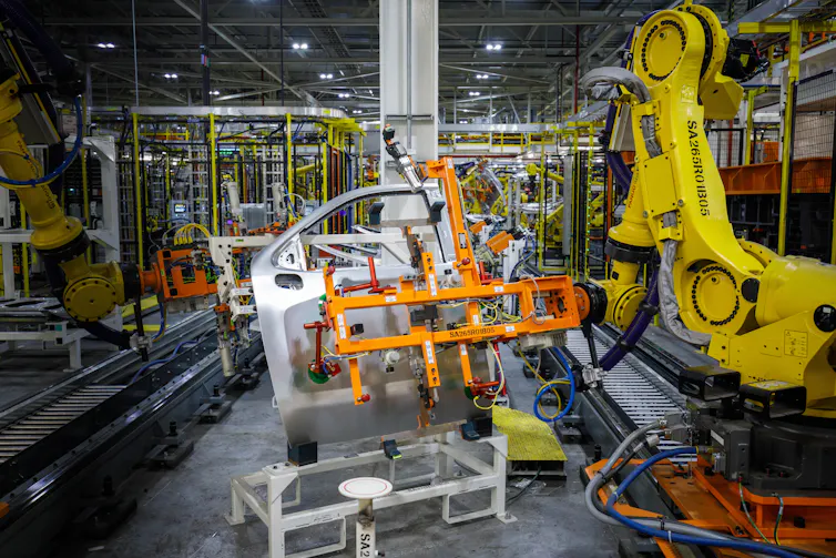 A steel and aluminium door is welded in a factory.