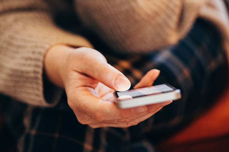 Close up of a woman's hand holding a mobile phone