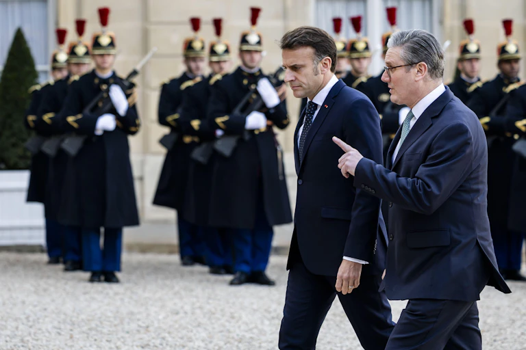 French president Emmanuel Macron, walks with US prime minister, Sir Keir Starmer, outside the Elysee Palace in Paris, February 2025.