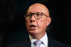 Man speaking at a microphone