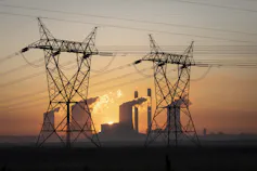 Power lines silhouetted by sunset