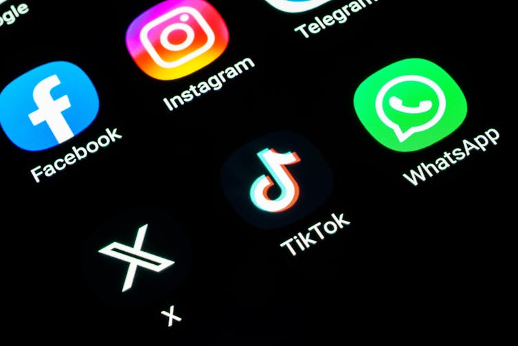 Icons of various social media applications such as TikTok and Instagram on a phone screen.