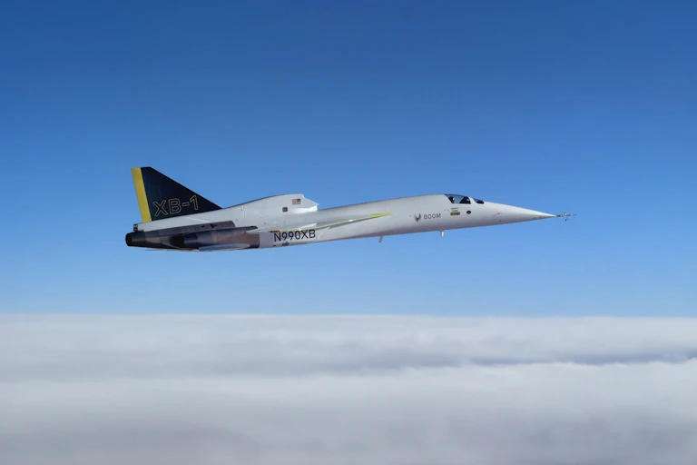 Jet plane flies above clouds