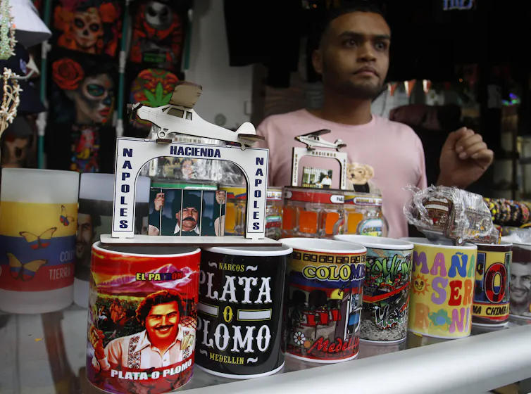 A man offers souvenirs featuring Colombian drug trafficker Pablo Escobar in Medellín, Colombia.