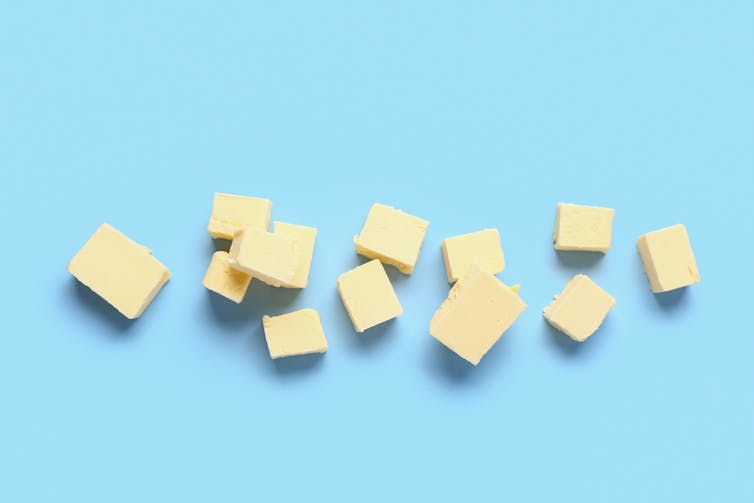 Cubes of butter against blue background