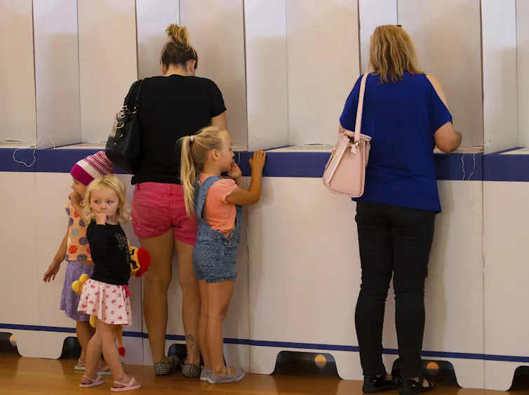 People cast their vote at a polling booth.