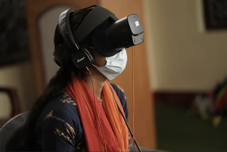 A young woman wearing a virtual reality headset.