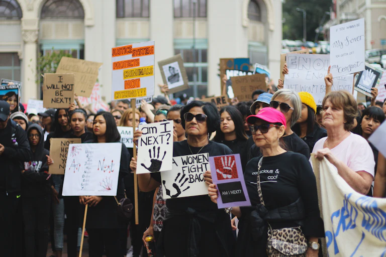 Women carrying banners with the words 'Ám I next', march against rape and femicide in South Africa.