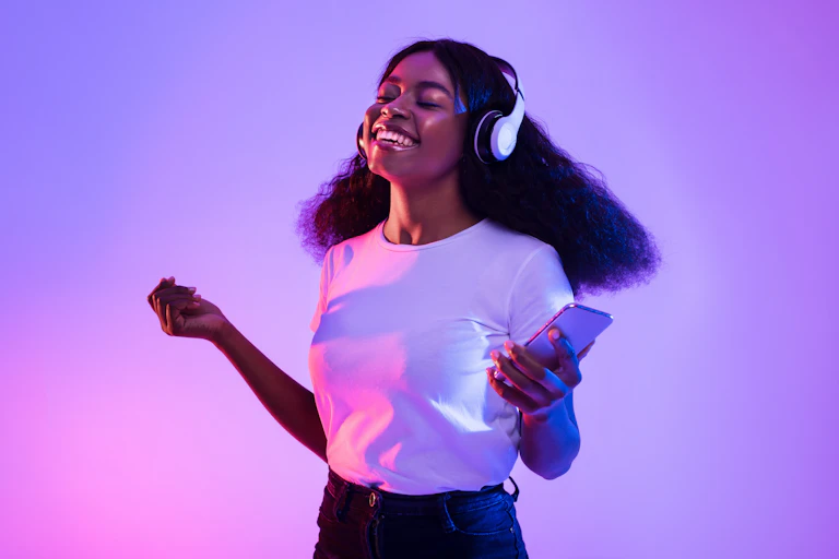 Young Black woman listening to music through headphones