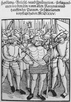 A black-and-white sketch showing several people standing with spears and other weapons.