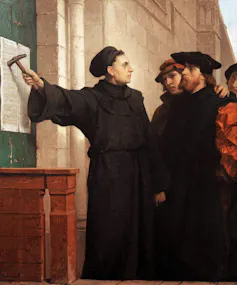 A painting depicting a man in a black cloak standing against a wall, holding a hammer and a piece of paper, surrounded by several others.