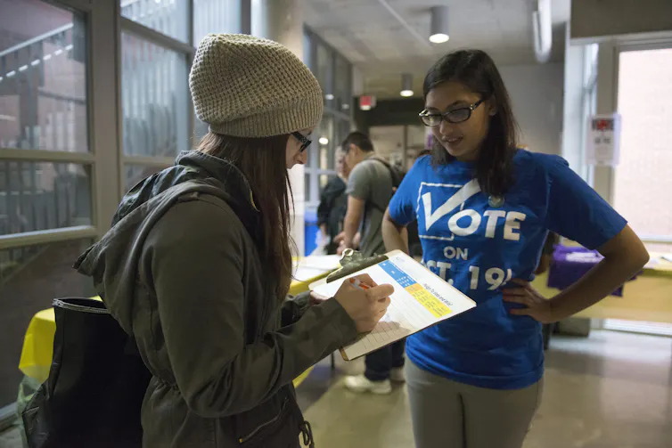 A person with a tshirt that says Vote.