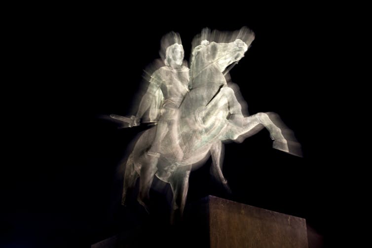 A ghostly horse and its ancient rider are displayed white against a black background.