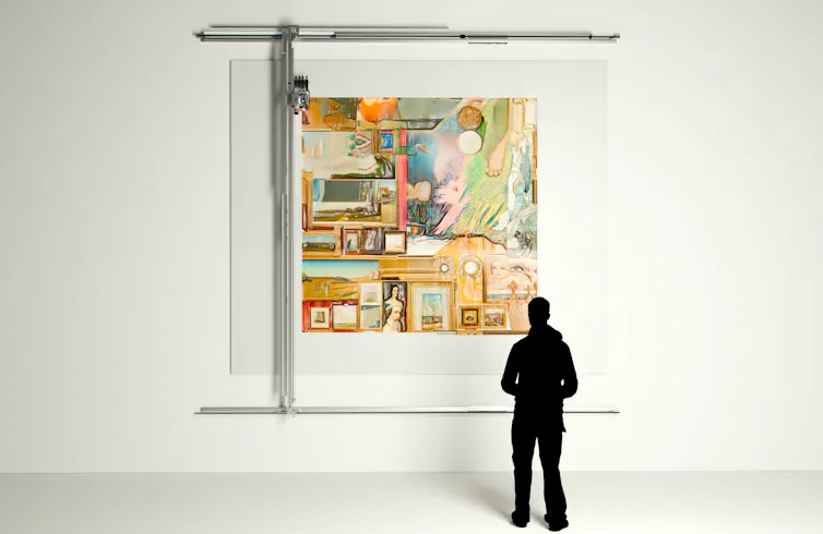 Photo of a person's silhouette standing in front of a robotic apparatus producing a large oil painting on a gallery wall.
