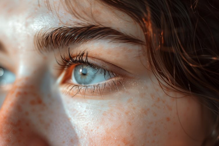 Woman looking upwards towards light