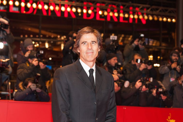 I’m Nonetheless Right here: a colourful testomony to feminine resilience that mourns Brazil’s darkish previous 1 A middle-aged man in a suit standing on the red carpet at the Berlin film festival.