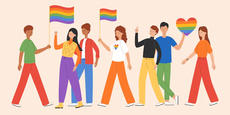 An illustration of a group of people holding rainbow flags.