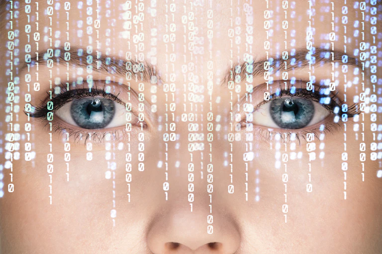 Close-up view of eyes and nose with stylised binary code superimposed over them