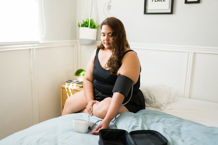 Woman takes her blood pressure