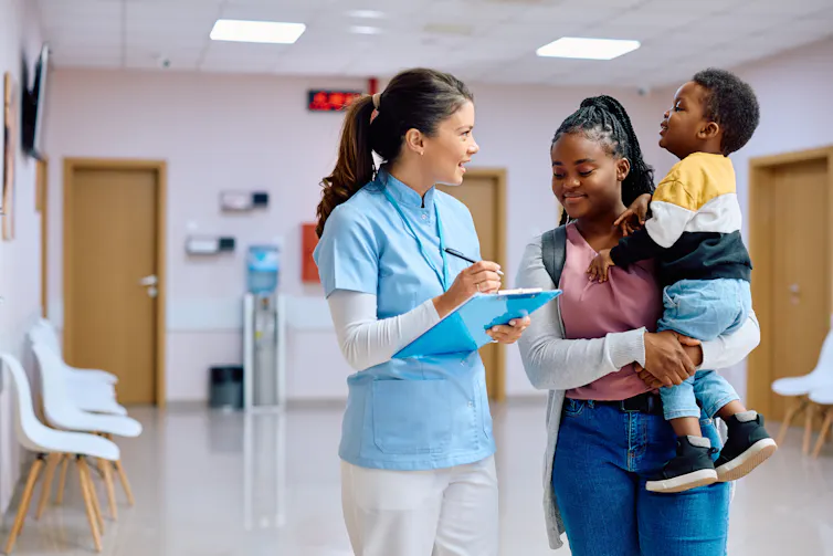 Nurse talks to mother and toddler
