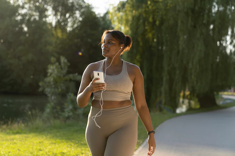 A woman walking in a park.
