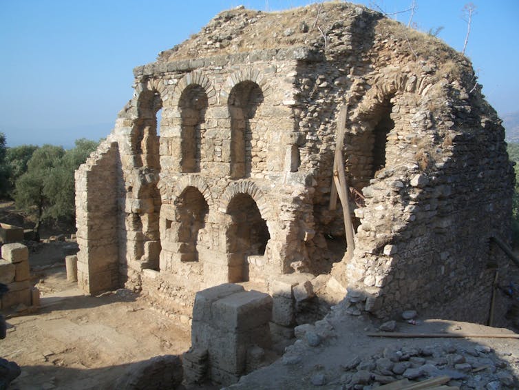 Crumbling stones in a two-story structure with arched niches.