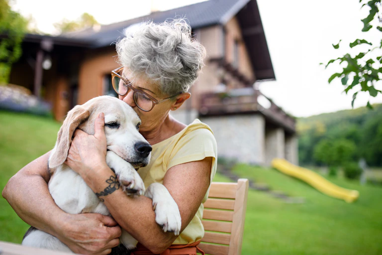A woman hugs her dog.