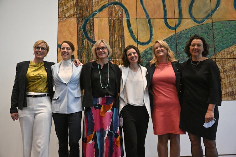 Six female politicians stand together for a photo.