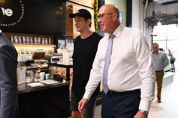 Peter Dutton walks and talks with business owners in Brisbane.