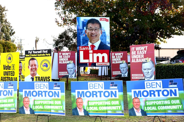Different political signs pitched a carpark.