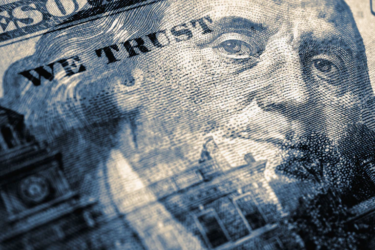 composite image of a 100 us dollar bill and face of benjamin franklin