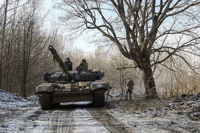 A Ukrainian tank in a snowy forest.