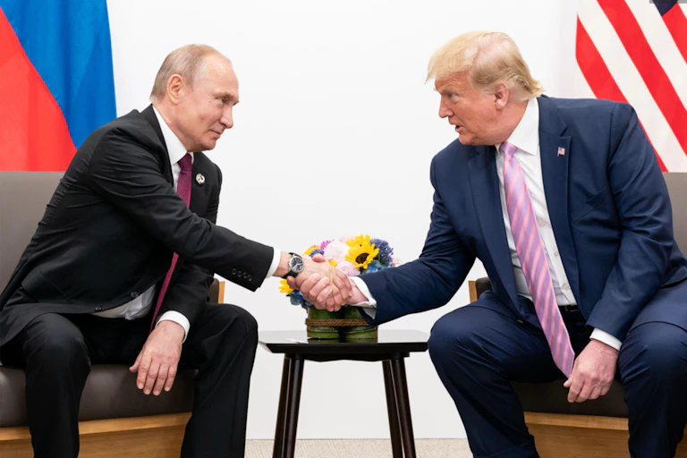 Russian president Vladimir Putin shakiong hands with US president, Donald Trump, as they meet on the sidelines of the G20 in Japan, June 2019.