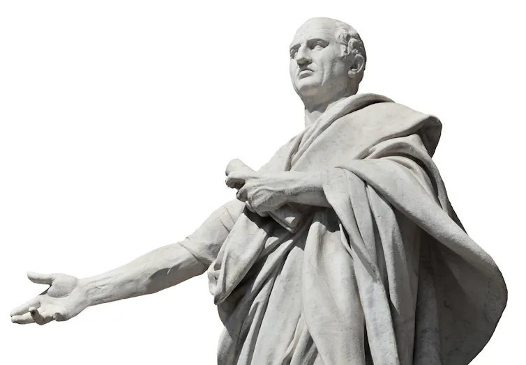 White statue of balding man wearing a loose tunic and holding a scroll.