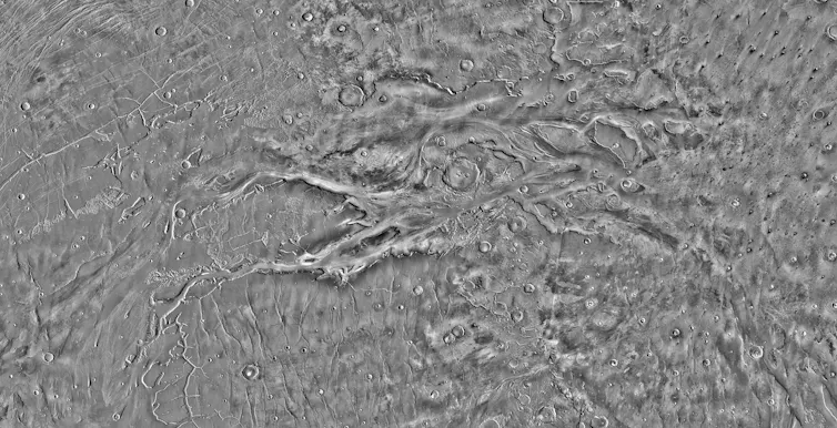Aerial image of a landscape cut with channels and canyons.