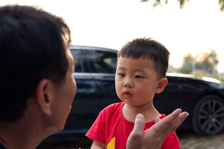 A man talks to a young boy.