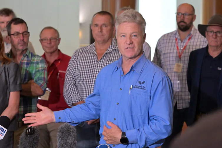 man standing at press conference