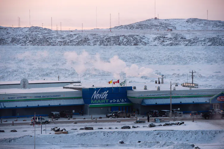A large building with the words North Mart written on it in a snow covered landscape.