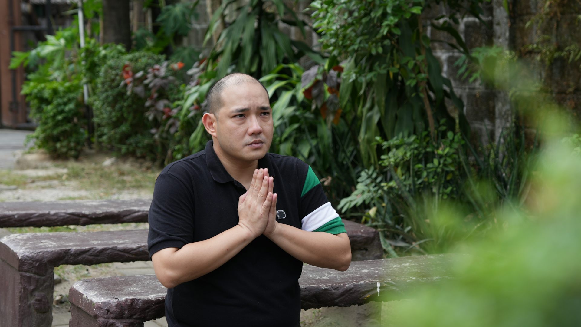 A man who was trafficked to a compound praying. 
