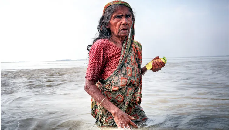 Asian woman in flooded water