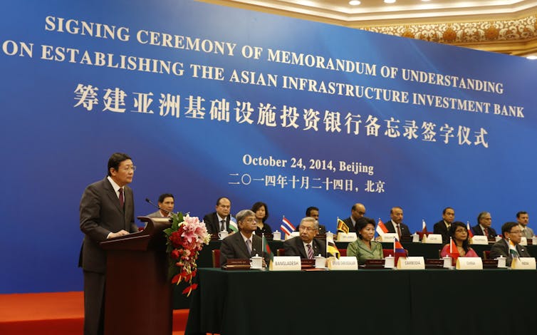 A group of men and women sits during a forum.