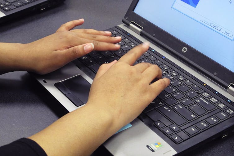 Hands seen on a keyboard.