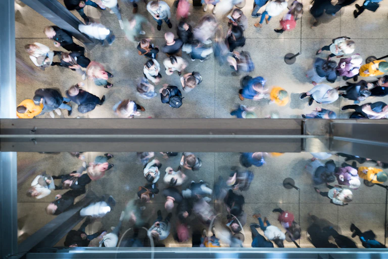 Top view of a crowd of people standing in a hallway