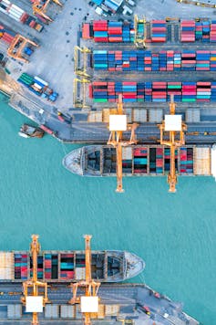 aerial view of shipping containers and cranes